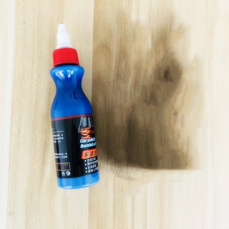 Small blue automotive scratch repair kit with repair agent bottle and applicator sponge for car paint damage