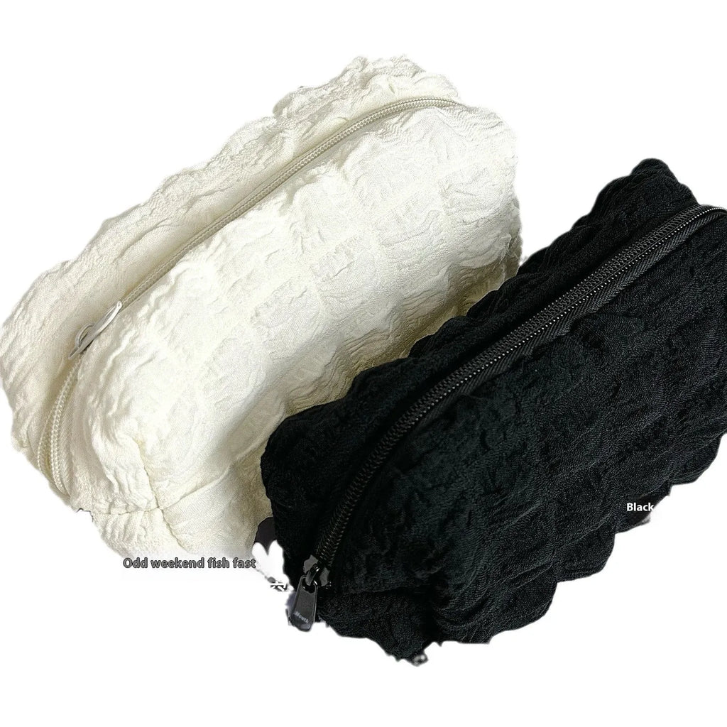 Beige and black fabric pencil case made from polyester for organising stationery.