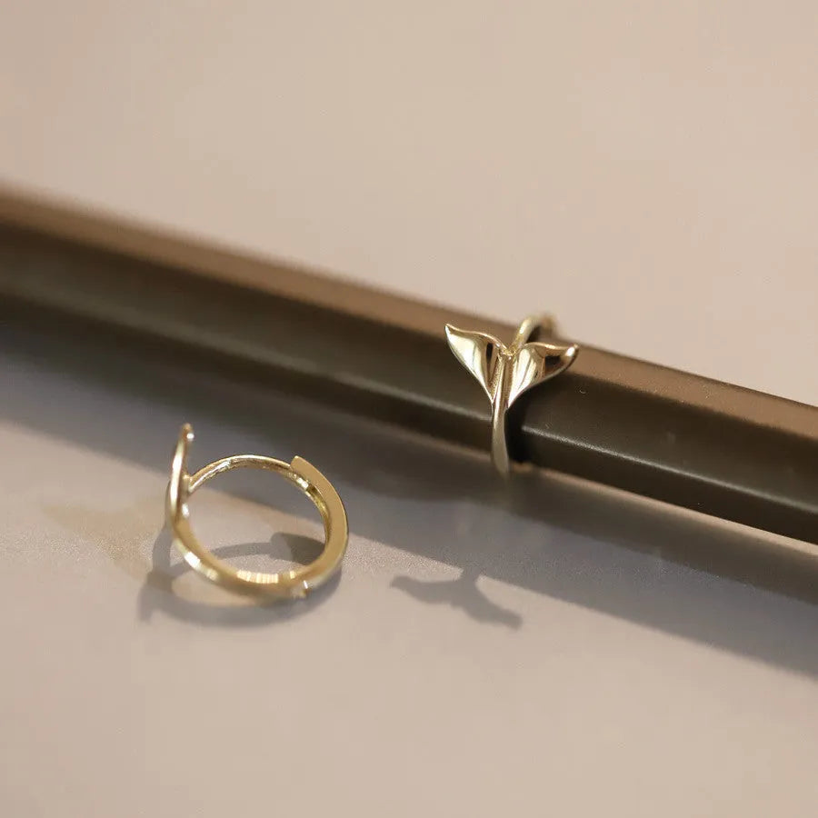 Women's sterling silver fishtail earrings in gold colour with smooth band design