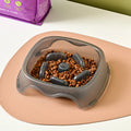 Blue plastic dog slow feeder bowl with interior ridges to control eating speed
