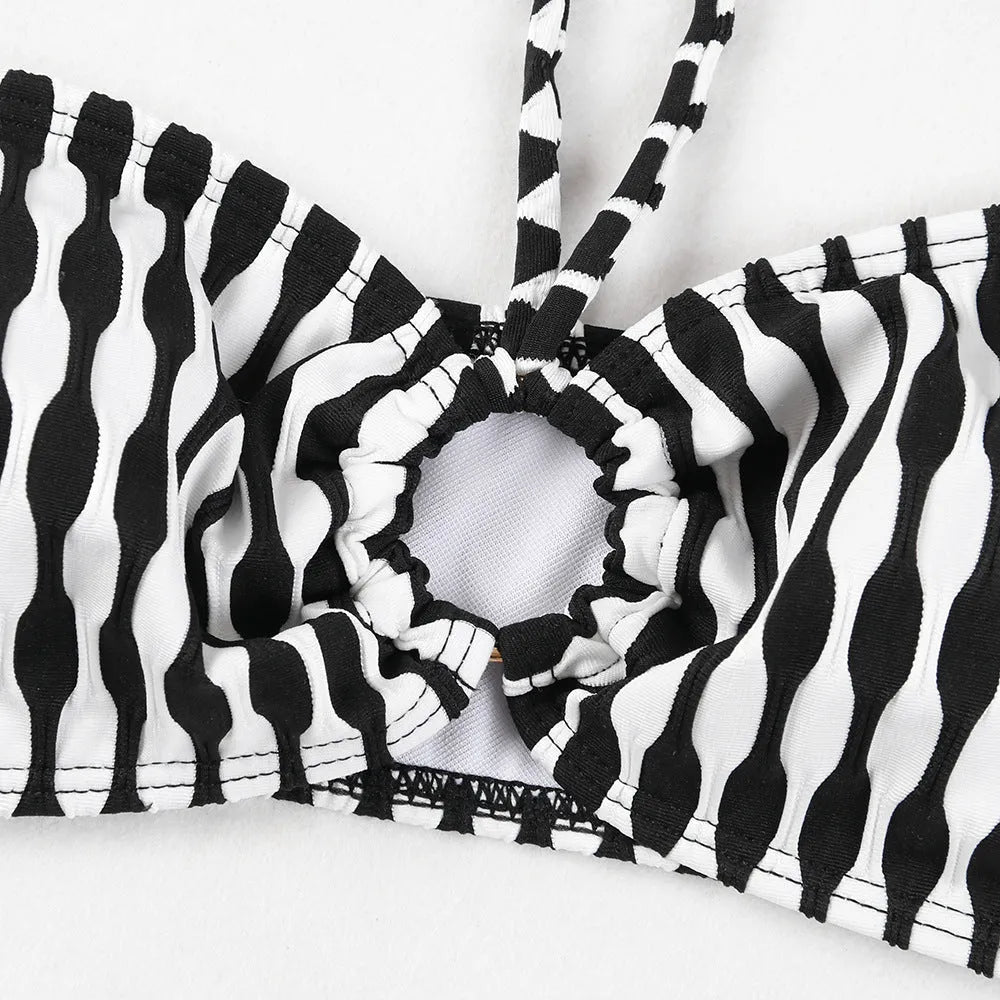 Women's striped three-piece swimsuit set with tube top, shorts, and waist skirt hem in colour option as pictured.