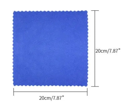 Blue labelled rust remover spray bottle next to a blue square sponge and a white towel on a grey background.
