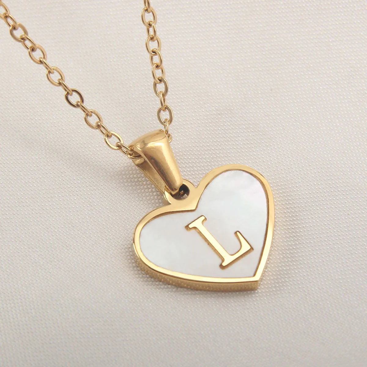 Gold plated heart necklace with white shell detail on an adjustable chain