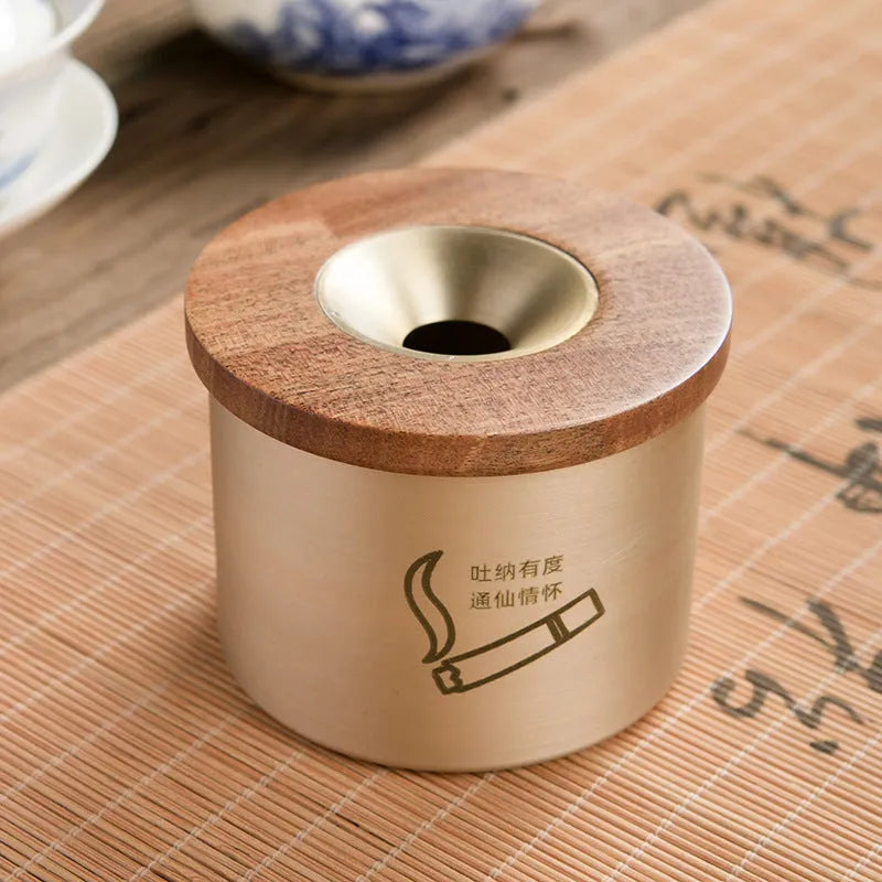 Retro brass ashtray with solid copper construction and hinged wooden lid featuring central circular aperture