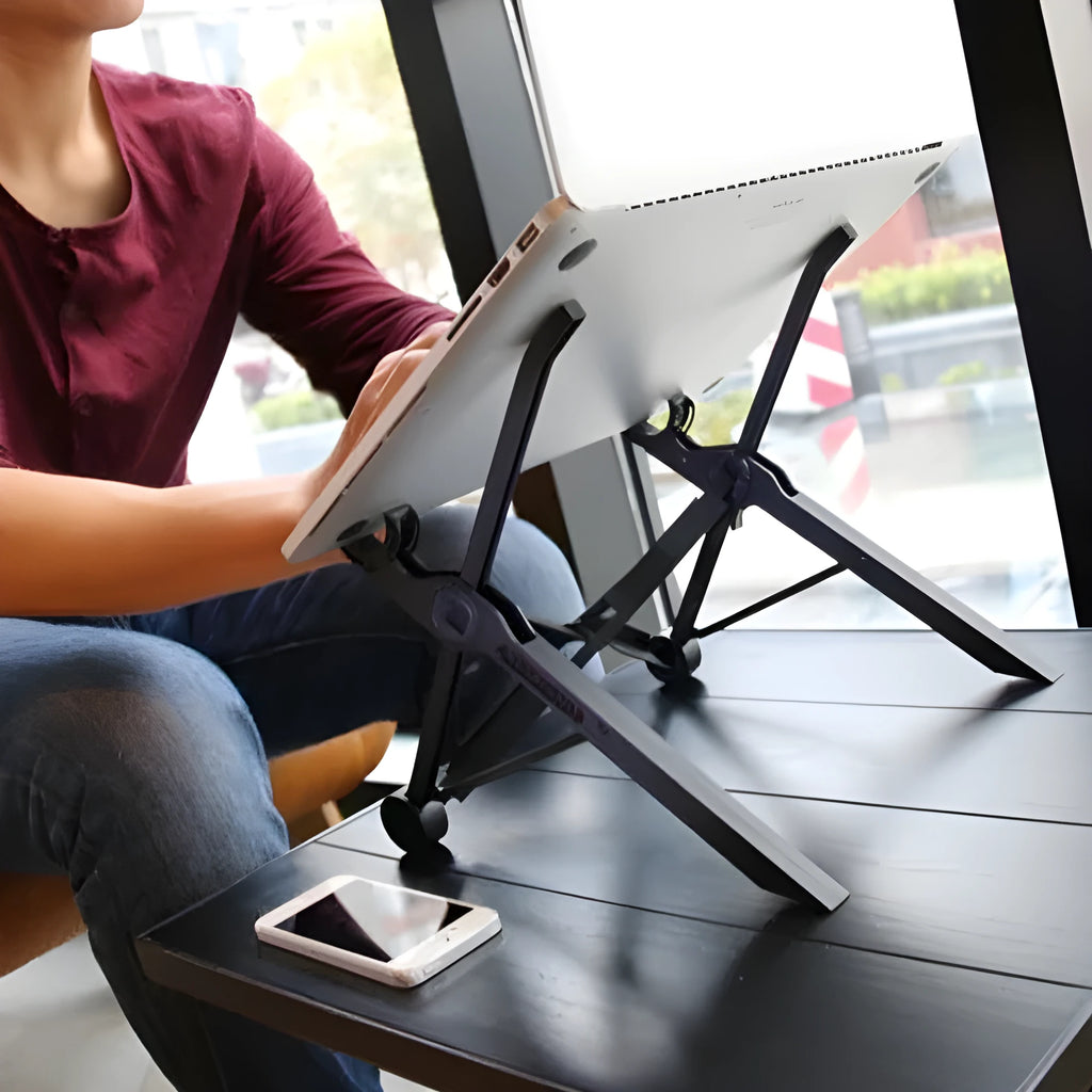 Black portable folding laptop riser on desk with 40cm wide platform