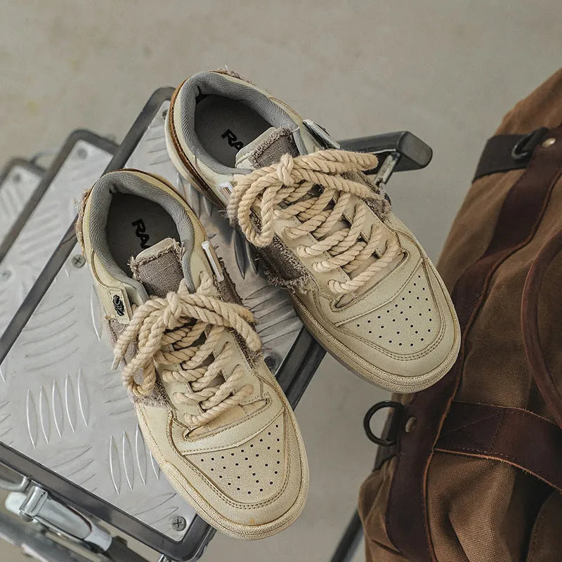 Beige low-top skateboard shoes with microfiber upper and rubber sole on white background