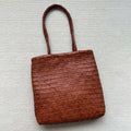 Brown handmade woven tote bag with three-dimensional pocket made from cowhide leather