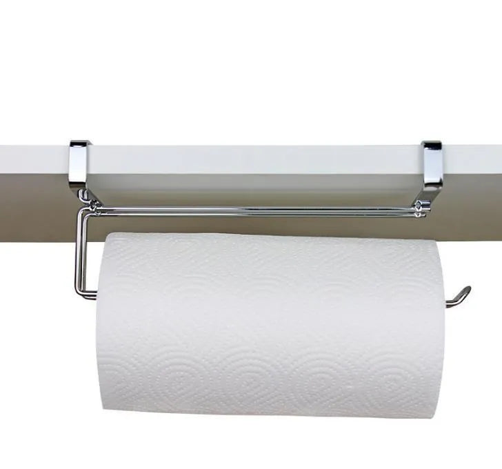 Silver stainless steel paper towel rack hanging on kitchen cabinet door