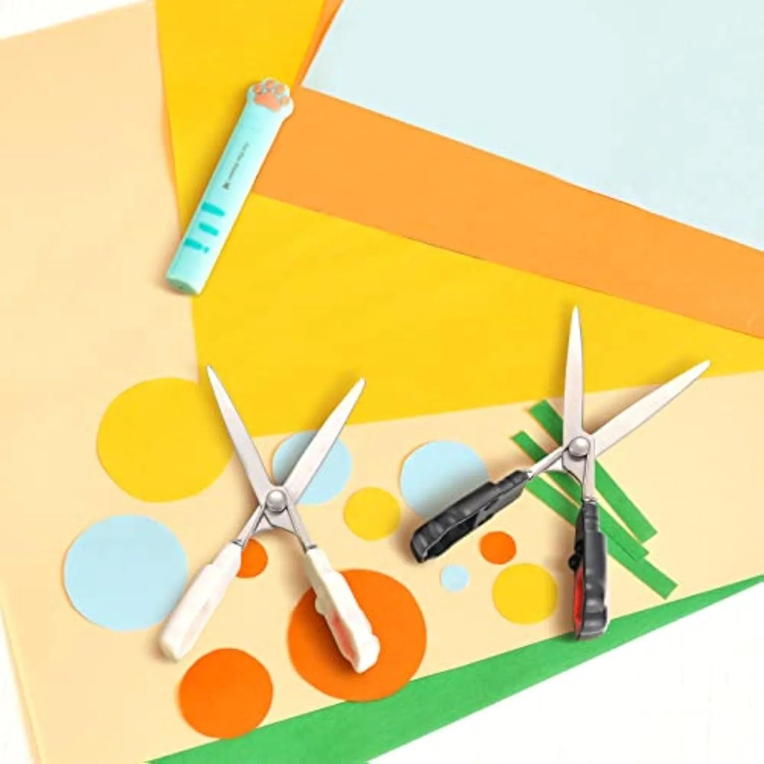 Closed cat paw design folding scissors showing stainless steel blades and handles in one of four colours.