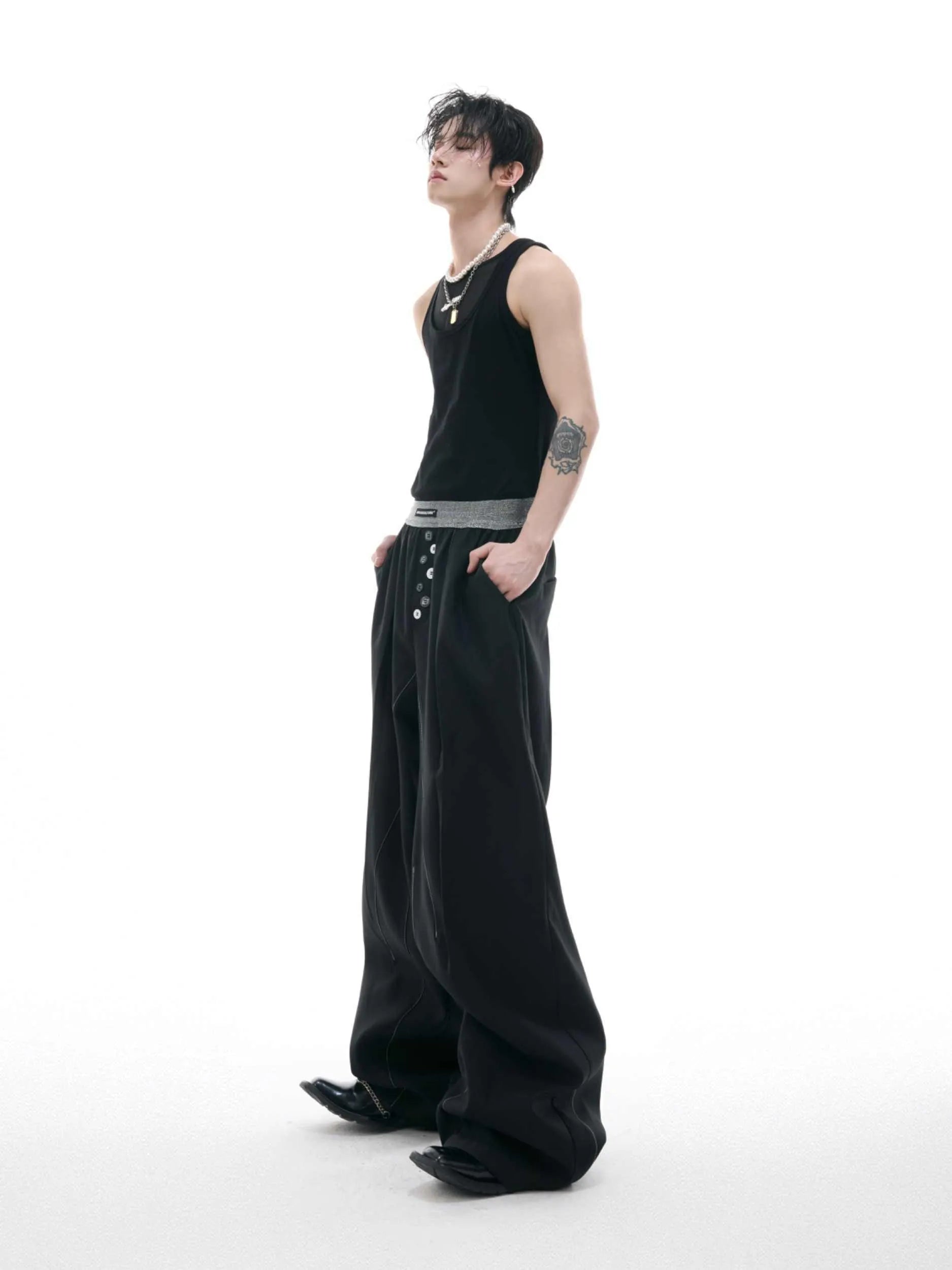 Man's black high-waisted straight-leg casual trousers with a button fly.