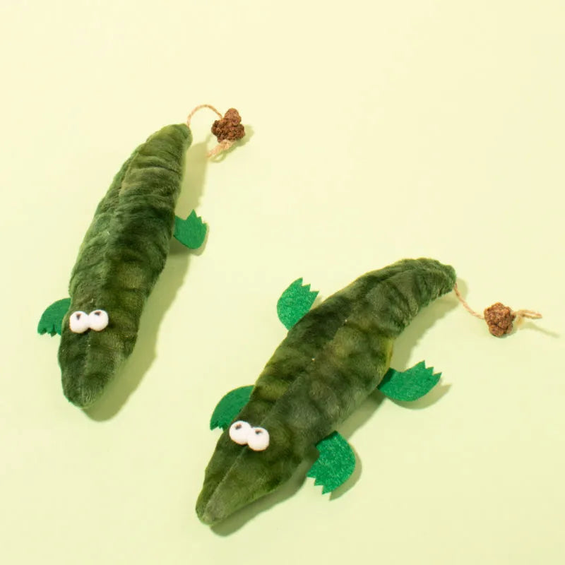 Green alligator-shaped cat toy with catnip and peppermint scent for oral cleansing