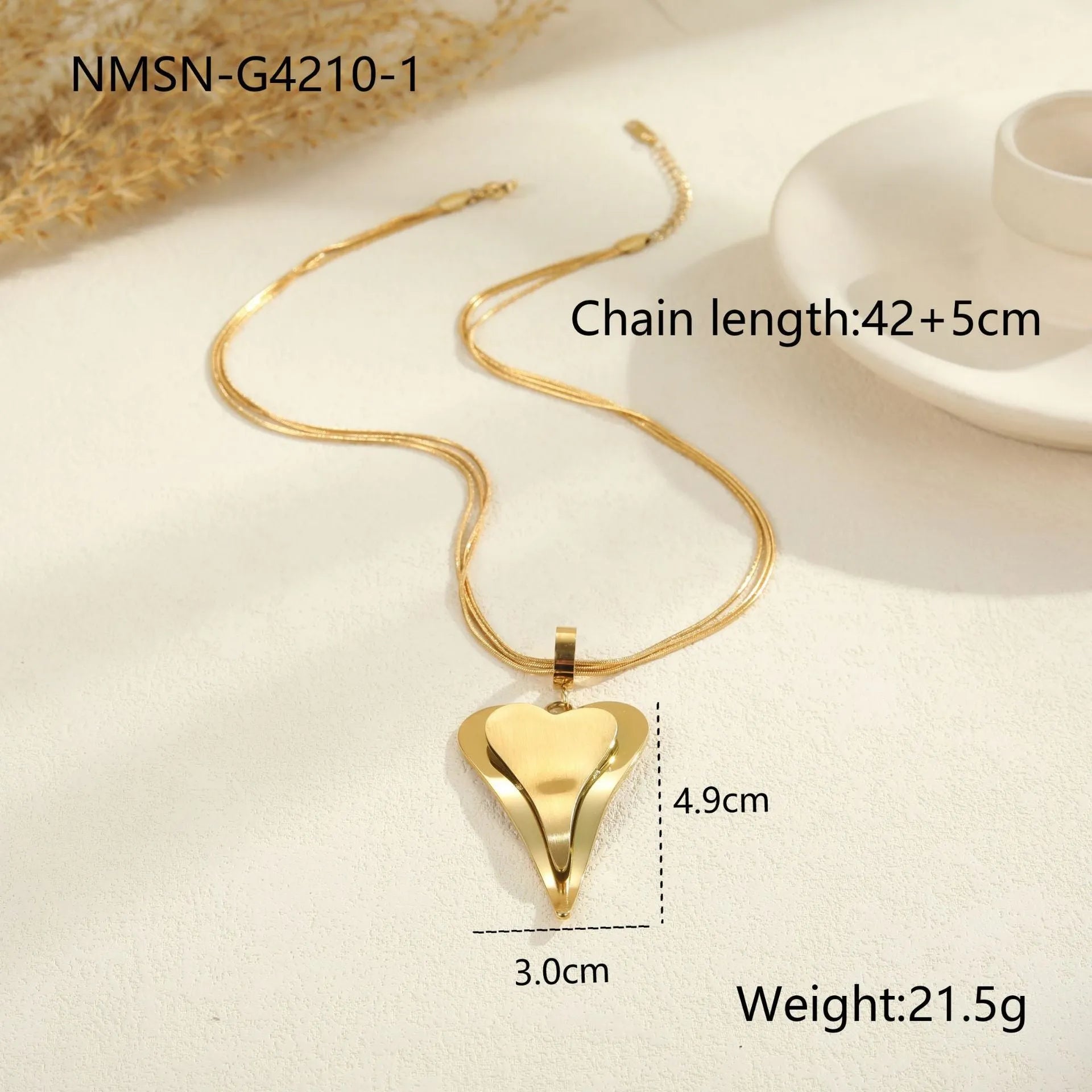 Geometric double heart pendant on a textured snake bones chain necklace in gold or steel finish.