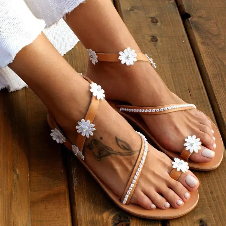 Brown women's Roman sandals with floral decoration on upper and flat rubber soles