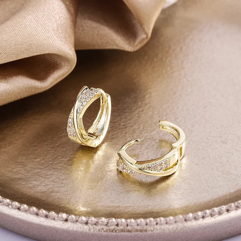 Pair of geometric drop earrings in 14K yellow with zircon treatment on a copper base.