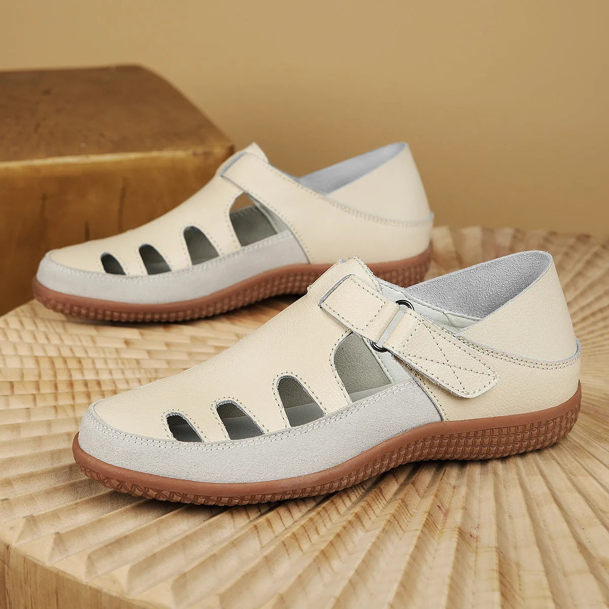 Women's flat sandals with hollow-out toe cap design in blue colour showing thick rubber sole