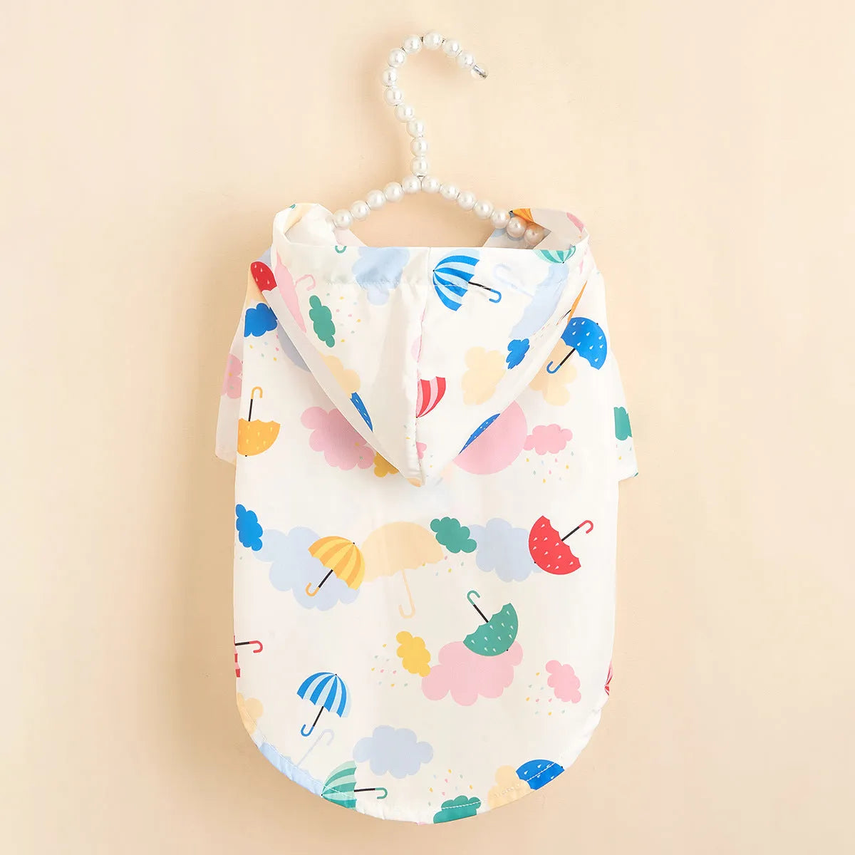 Colourful cartoon umbrella print dog raincoat in polyester fabric on a model dog.