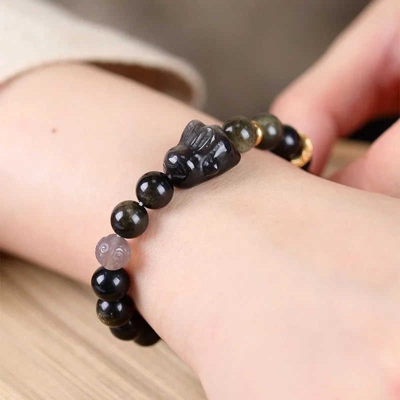 Handmade lying rabbit obsidian bracelet with Jin Yaoshi beads and brass details in national style.