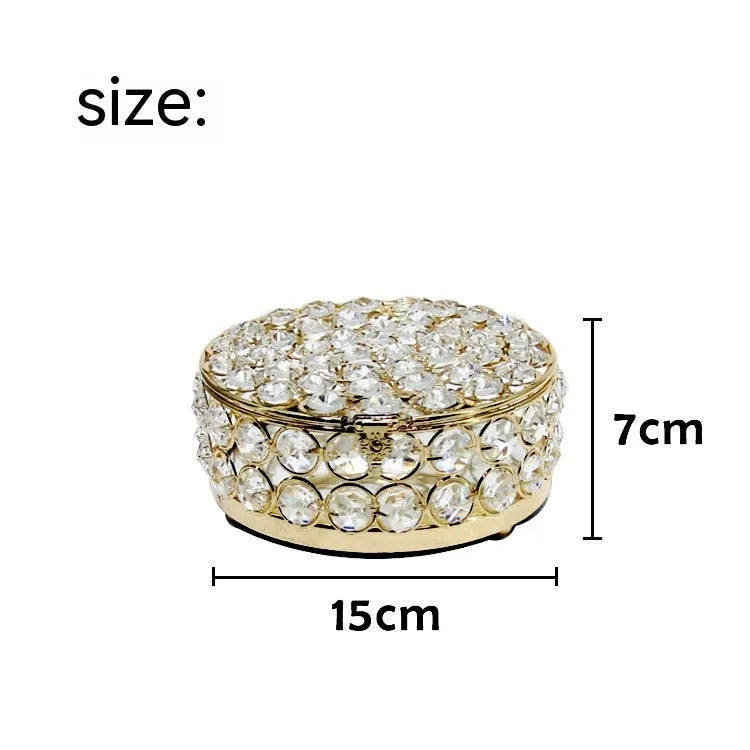French gold metal jewelry box with a clear crystal glass front panel on display.