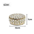 French gold metal jewelry box with a clear crystal glass front panel on display.