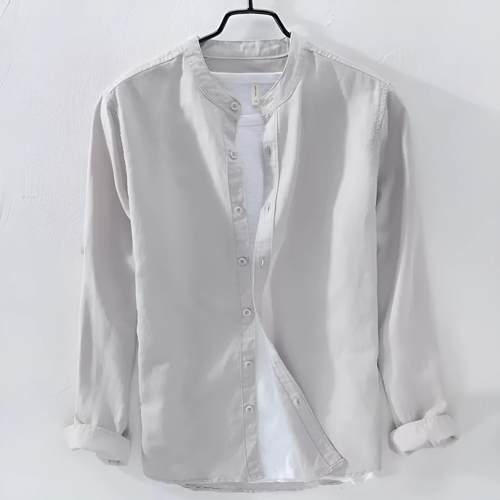 Loose fit long sleeve linen shirt in solid colour on hanger showing casual collar and button front