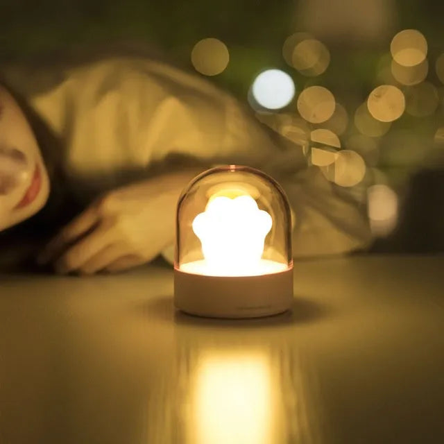 Grey or pink cat paw shaped night light with USB charging port and music box functionality