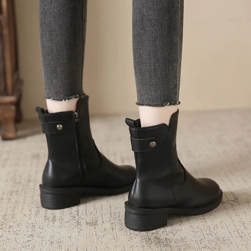 Black women's ankle boots with side zipper and round toe on low rubber heel