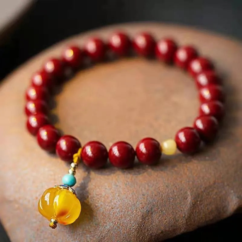 Handmade wave-shaped bracelet made from cinnabar and copper beads in a national unisex style.