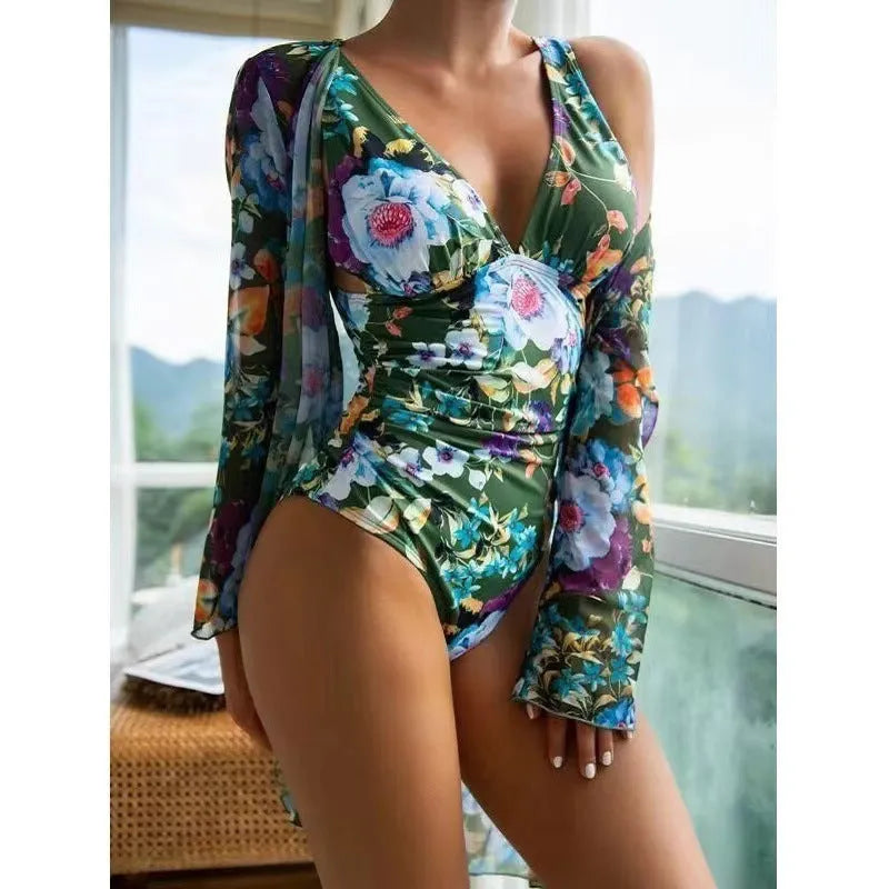 Women's floral print three-piece bikini set with a cover-up coat on a hanger