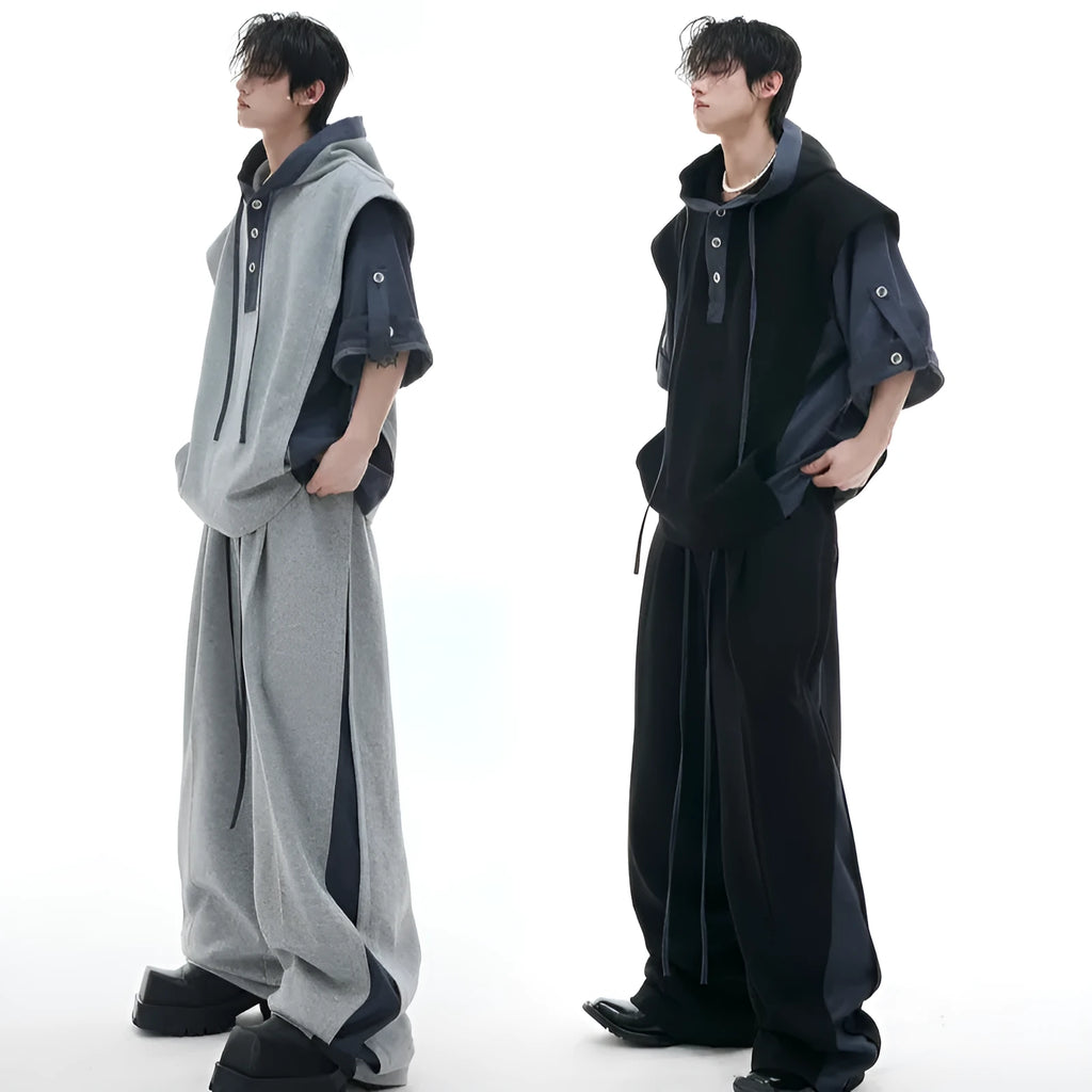 Man wearing a gray hooded short-sleeve sports jacket with 3D stitching and black matching trousers.