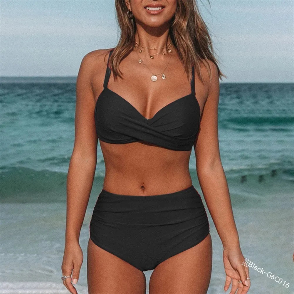 Women's solid colour bikini with cross-strap top and briefs, shown in dark blue.