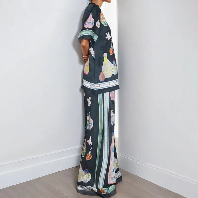 Black women's casual set with cartoon print, featuring sleeveless cardigan and trousers.