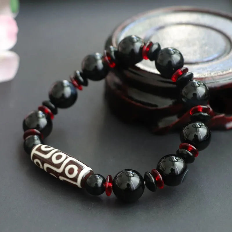 Black agate dzi bead bracelet with chalcedony stones and hand-woven design