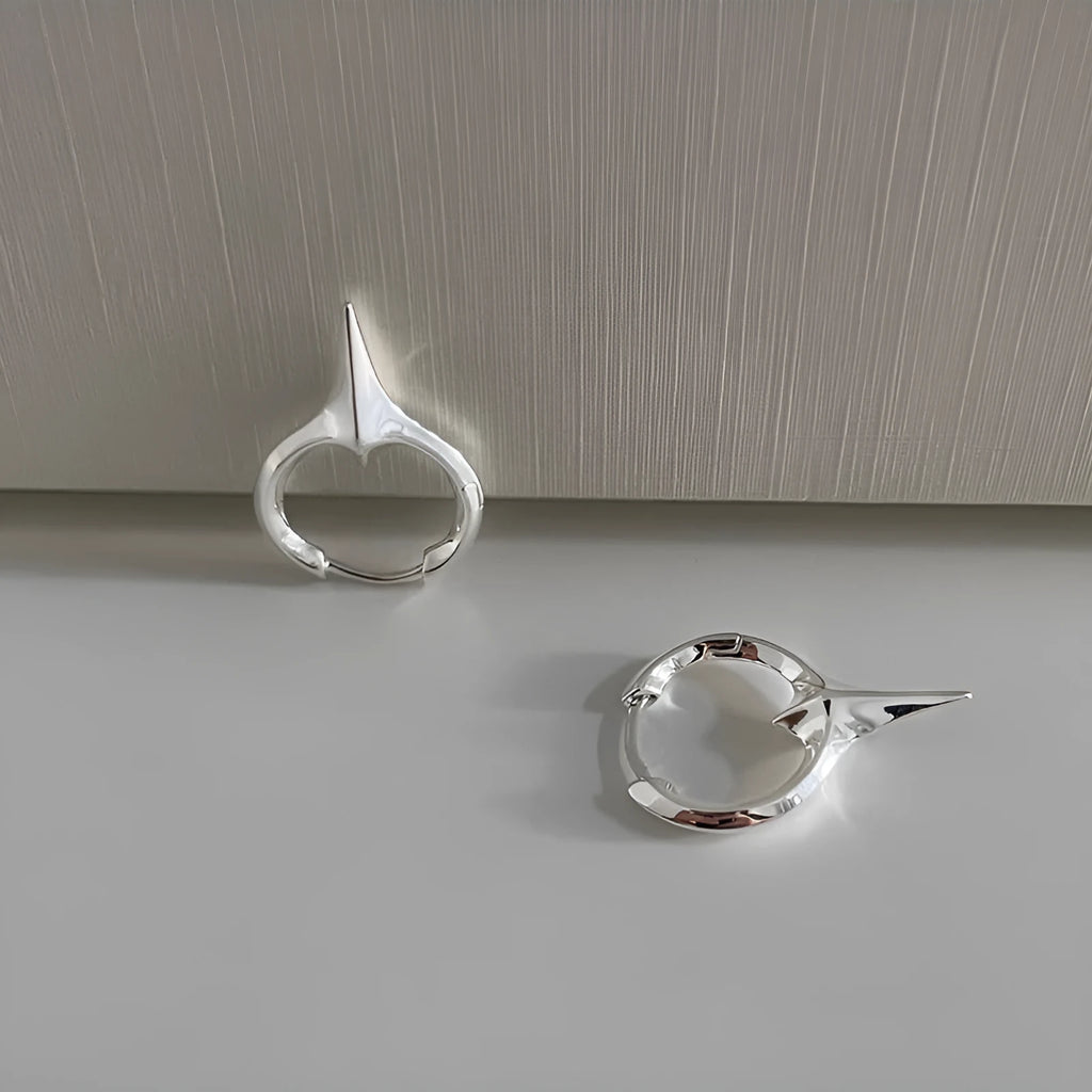 Geometric star-shaped women's ear clips in a platinum colour with a clip-on fastening.