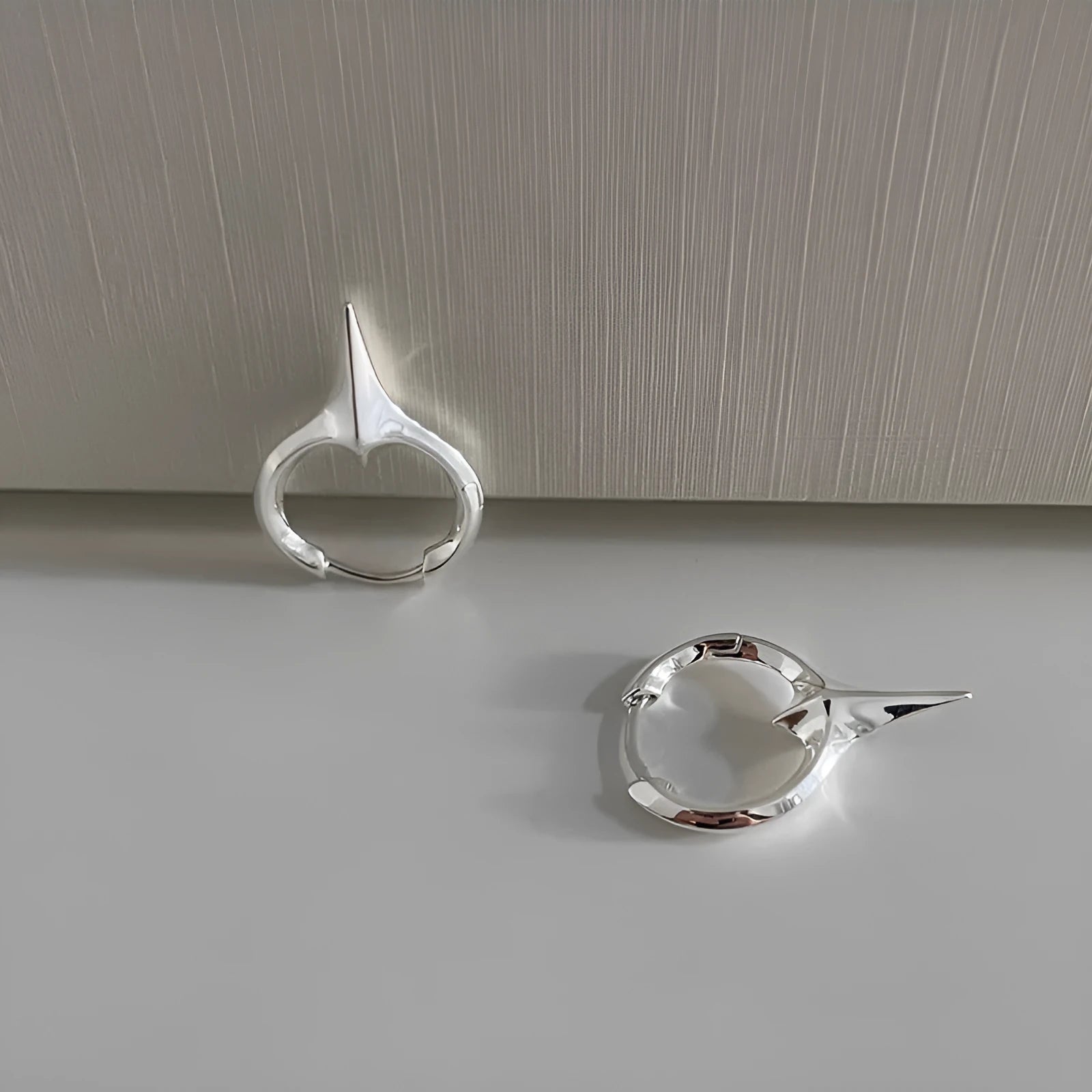 Geometric star-shaped women's ear clips in a platinum colour with a clip-on fastening.