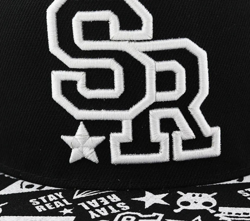 Black and white cotton baseball cap with letter embroidery on the front, showing adjustable strap.