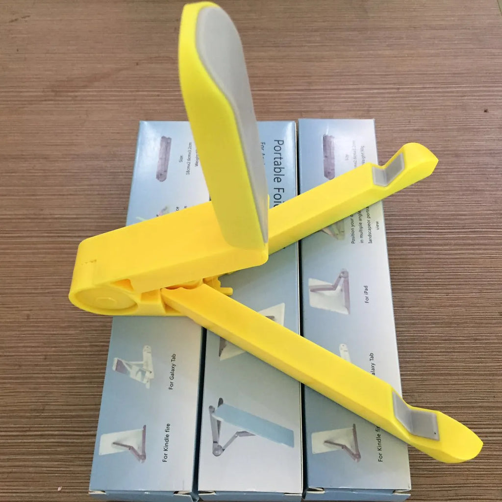 Black foldable tablet holder supporting tablet in landscape position on desk