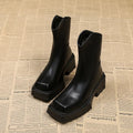 Black platform Martin boots for women with square toe and back zipper on a mid-calf.