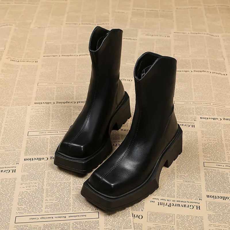 Black platform Martin boots for women with square toe and back zipper on a mid-calf.