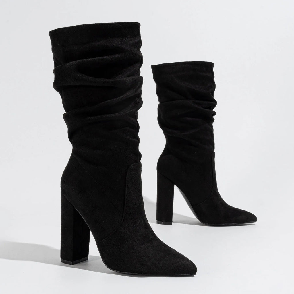 Women's black suede pointed-toe high heel boots with a chunky mid-calf design.