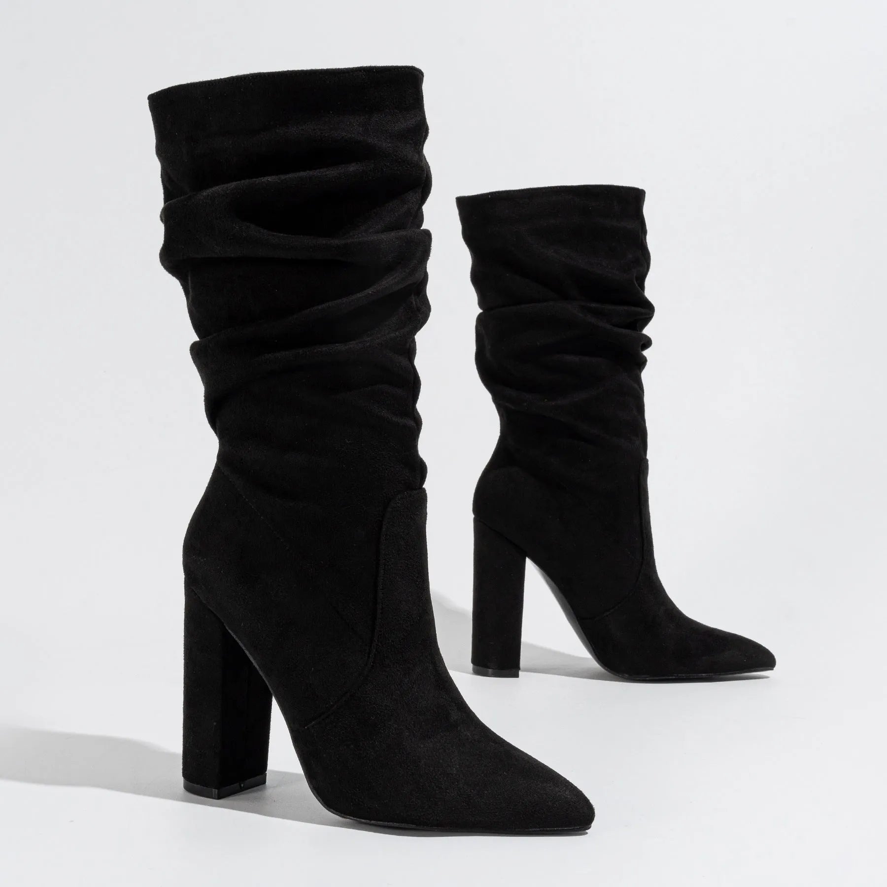 Women's black suede pointed-toe high heel boots with a chunky mid-calf design.