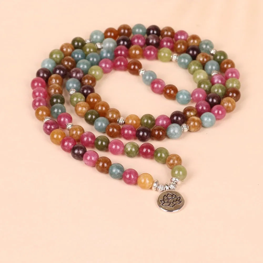 108-bead multi-layer alloy bracelet in a tourmaline colour, shown hanging and as worn jewellery.