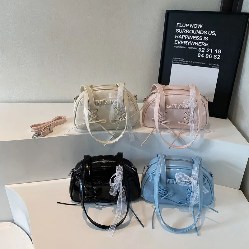 Women's fashion shoulder handbag with bandage bow design in PU leather showing interior phone pocket