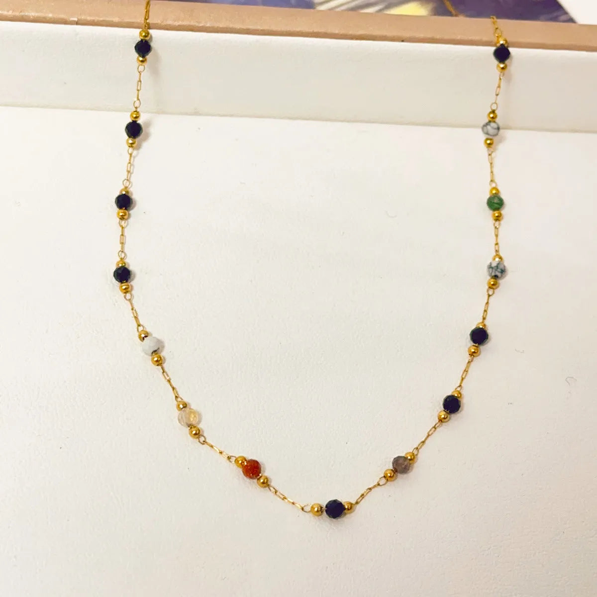 Women's titanium steel necklace with natural stone pendant and gold electroplated finish