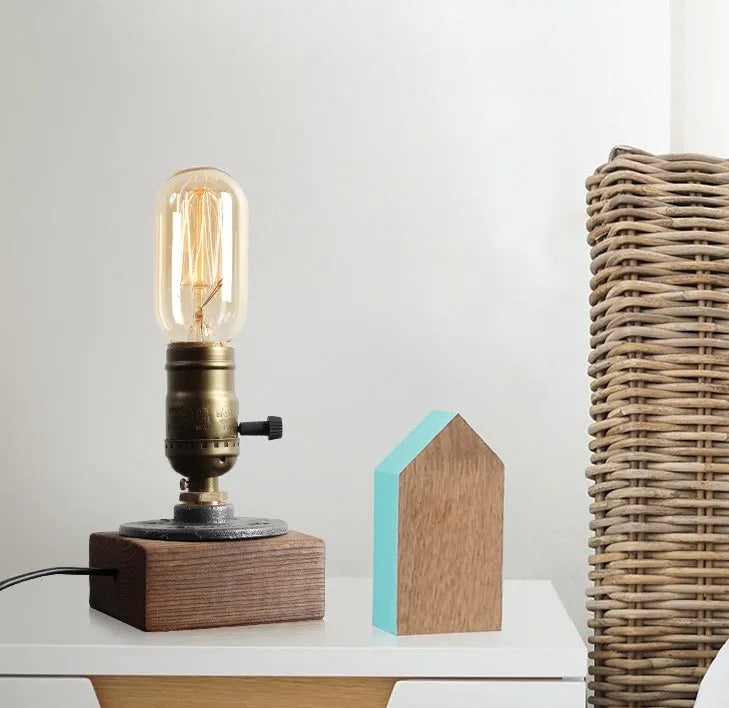 Wood and iron antique water pipe style table lamp on a surface