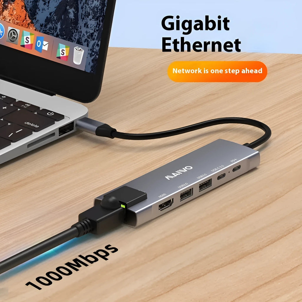 Aluminium Steam Deck six-in-one docking station with HDMI, USB, and Ethernet ports next to a handheld console.