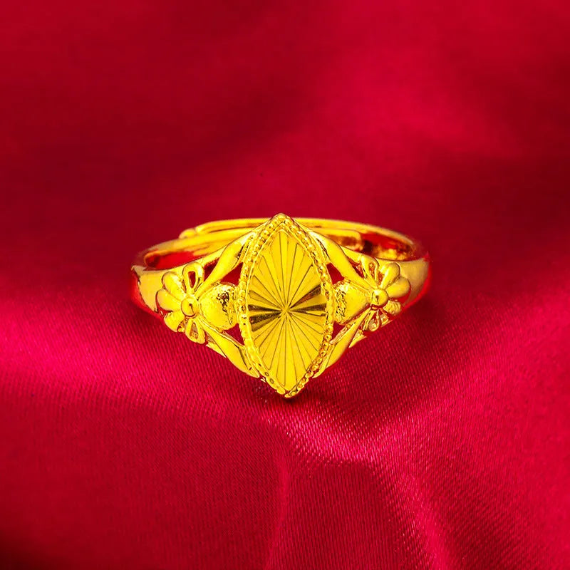 Geometric gold flower ring with open setting and textured details on brass base