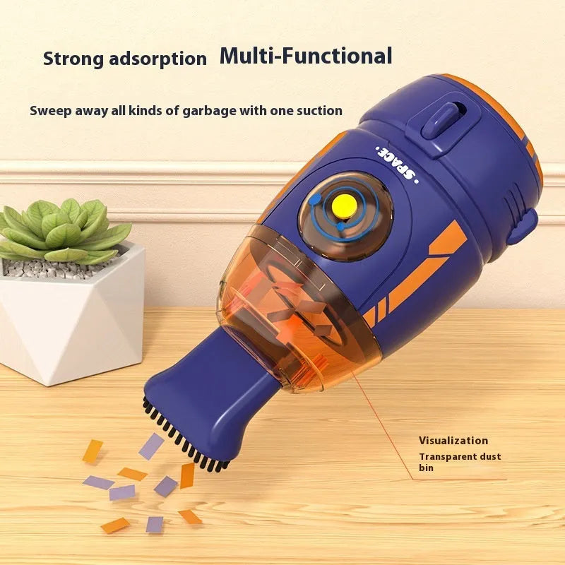 Handheld USB desktop vacuum cleaner in blue rocket design on a wooden desk next to a keyboard.