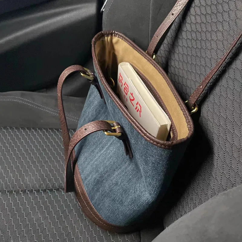 Denim patchwork handbag showing bucket shape with one-shoulder strap and patchwork detailing