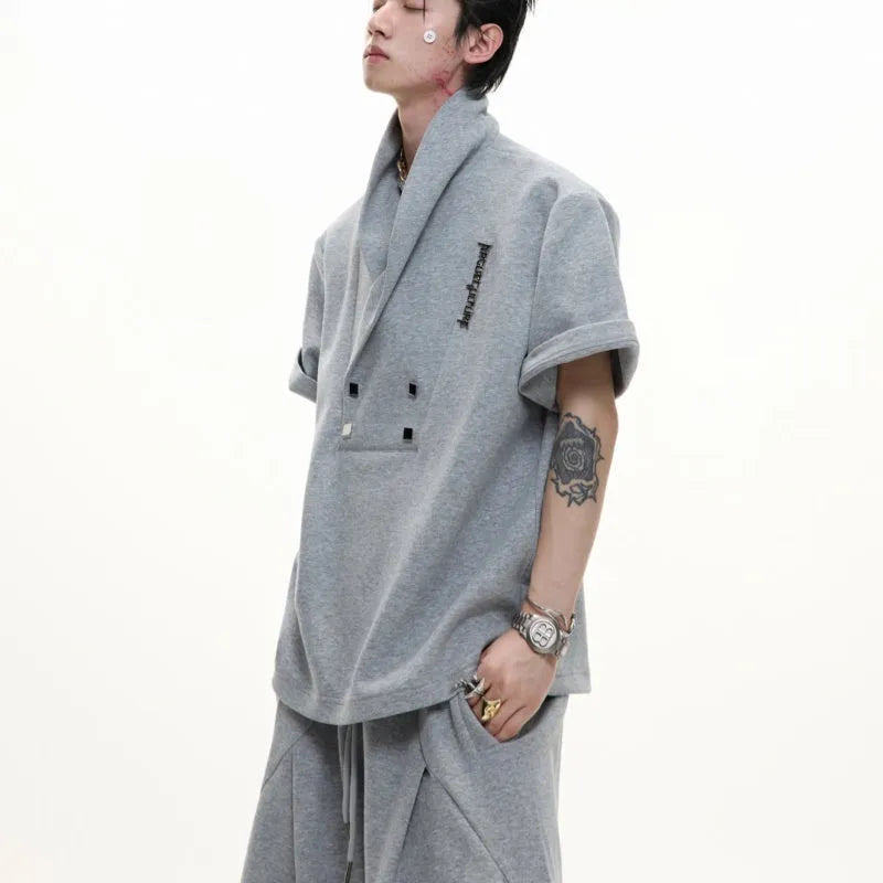 Men's dark grey cotton sports suit with metal-embellished V-neck jacket and matching shorts.