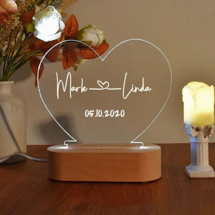 Custom acrylic night light with illuminated personalised names and dates for bedroom